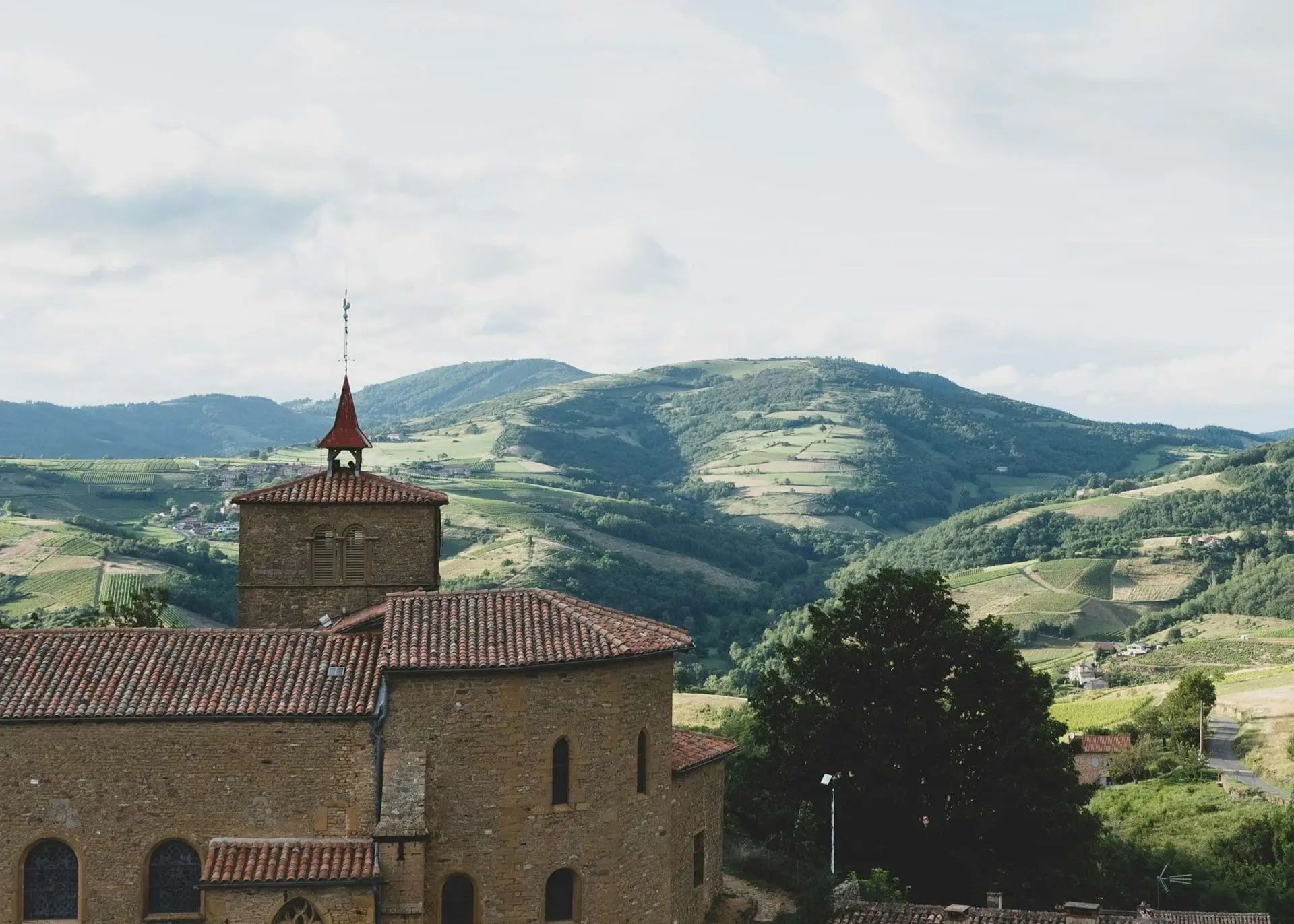 Church in Beaujolais with a bell tower in a hilly landscape